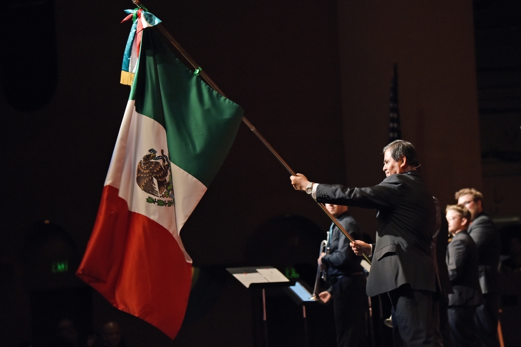 Man holding the Mexican flag.