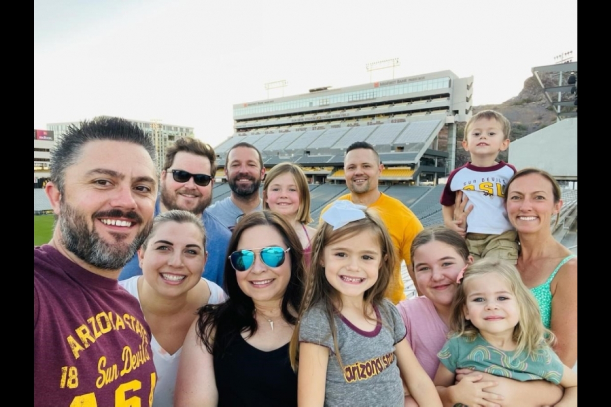 The West family and friends pose at Sun Devil Stadium