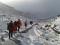 A group hikes into a snowy mountain range