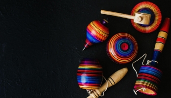 Brightly colored wooden toys on a black background.