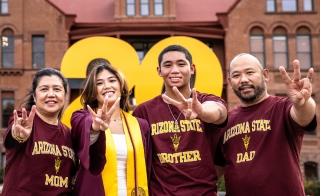 Four people wearing Arizona State shirts and making the pitchfork sign with their hands.
