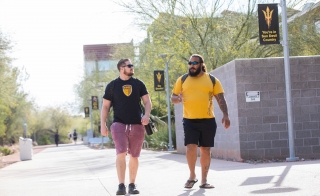 Two student veterans walking and talking on the ASU campus.