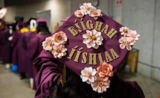 Close-up of a student's graduation cap, which reads "I did it!" in Navajo.