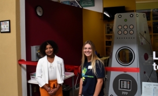 Cali Anderson and Savannah La Berge at Junior Achievement of Arizona BizTown standing in front of the ASU storefront and smiling.