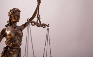 A statue of blindfolded Lady Justice holding scales.