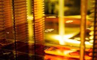 Semiconductor wafer on a rack lit by gold light