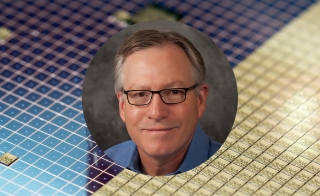 A portrait of Stephen Goodnick on a background of semiconductor material