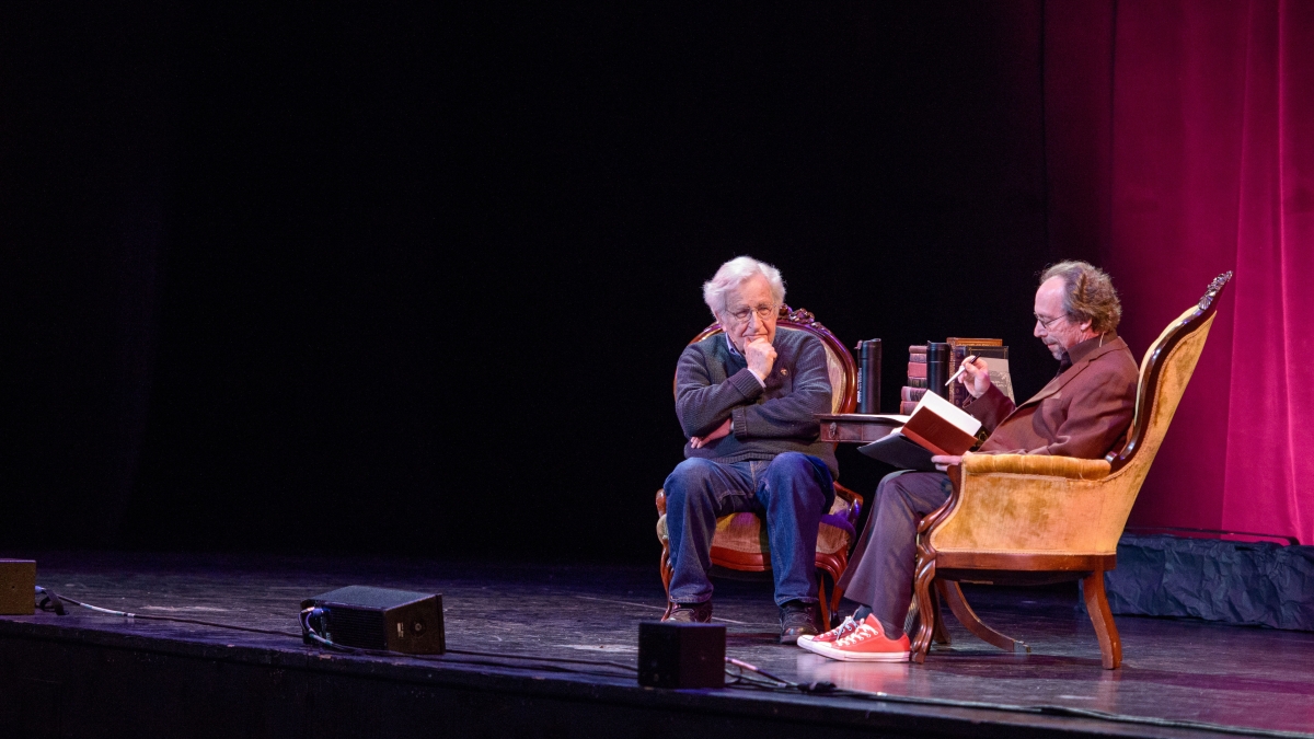 Noam Chomsky and Lawrence Krauss seated on stage at ASU Gammage