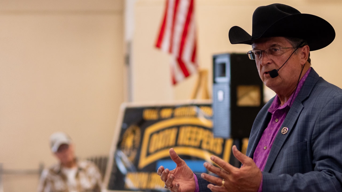 Photo of man in a cowboy hat giving a speech.
