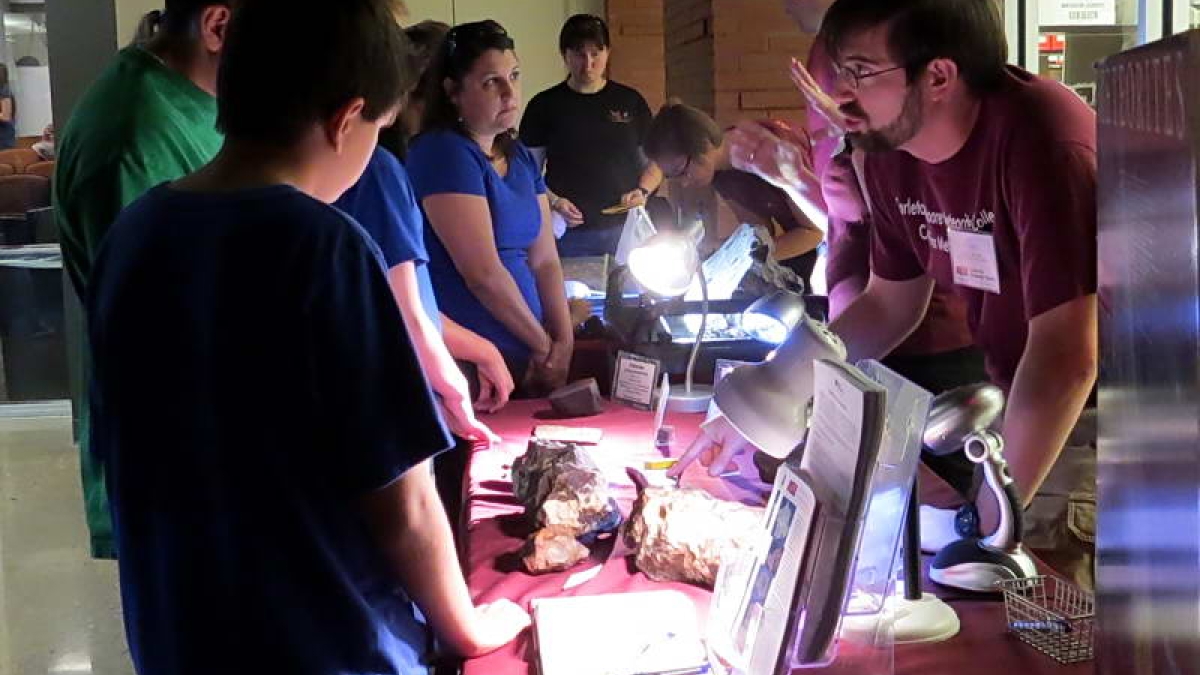 community members look at meteorites and engage with ASU scientists