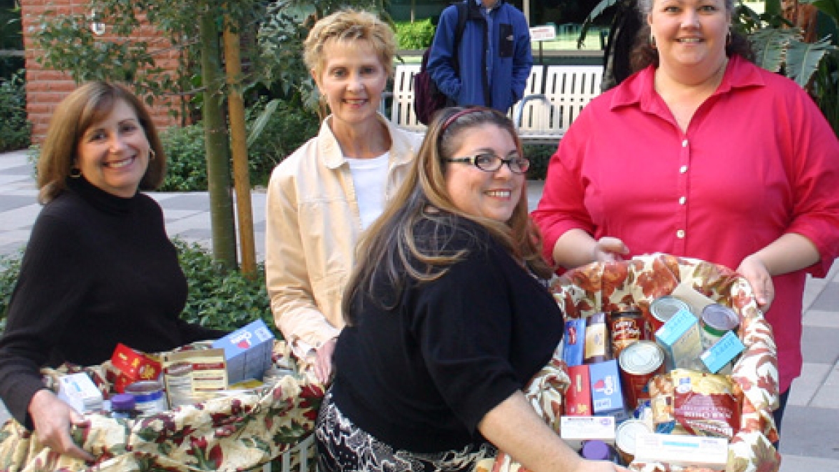 women with Thanksgiving food baskets