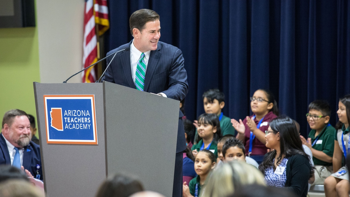 Gov. Doug Ducey speaks to elementary students onstage