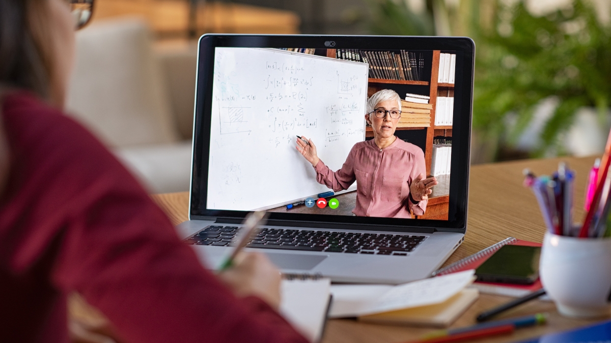 Stock photo of a professor teaching a class on a laptop screen