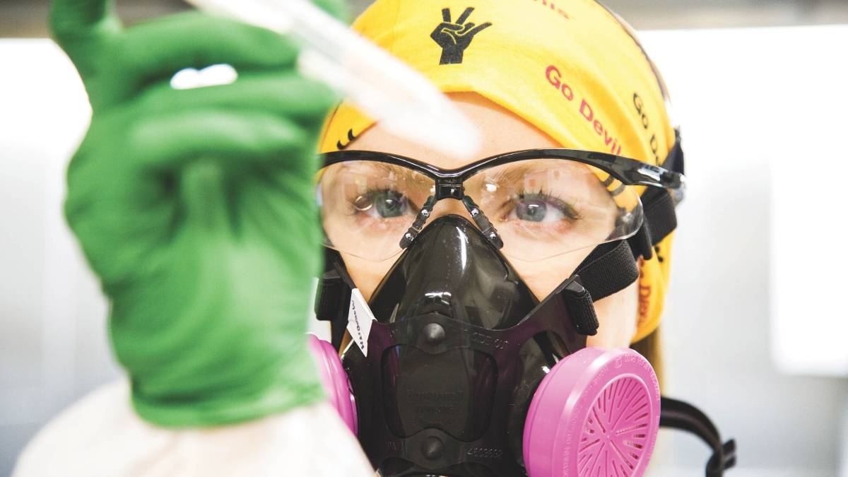 researcher in a lab wearing PPE
