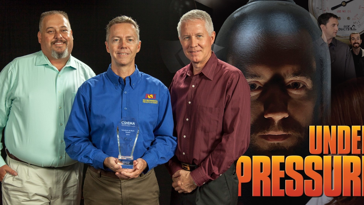 three men pose with an Environmental Health and Safety award
