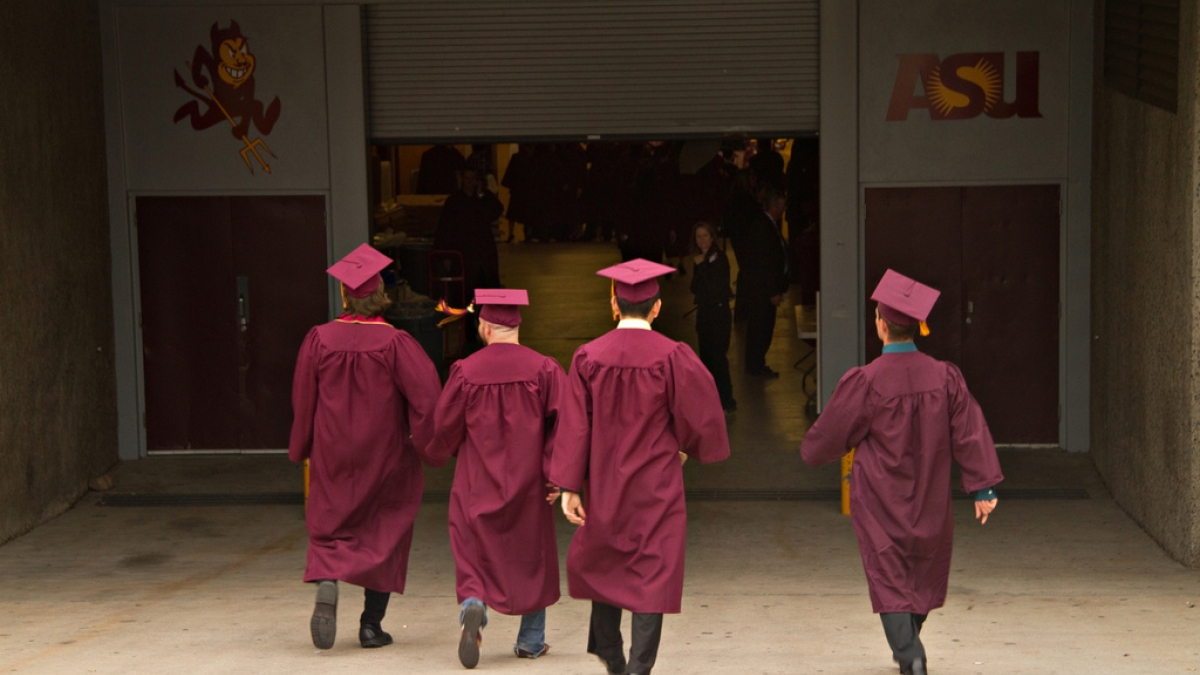 ASU graduates walking into Wells Fargo Arena for commencement