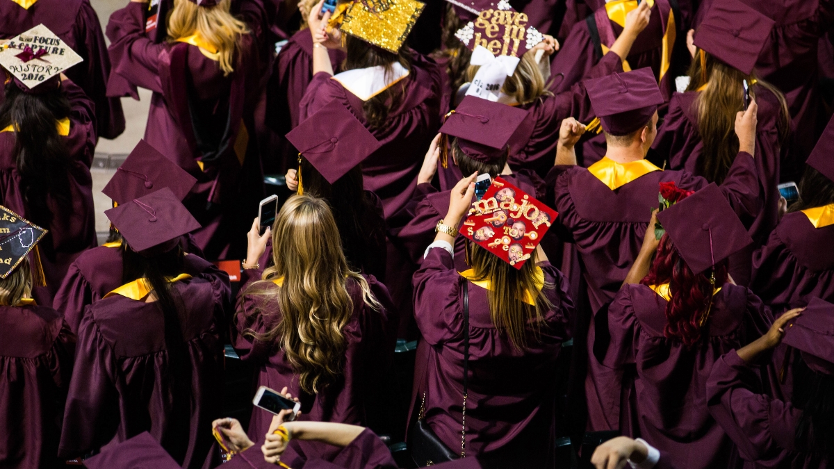 Overhead view of graduates in maroon caps and gowns