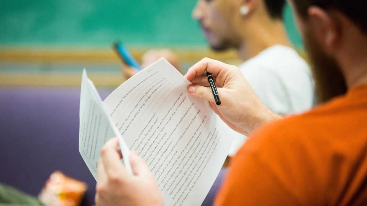 Participants look at a story during a creative writing workshop