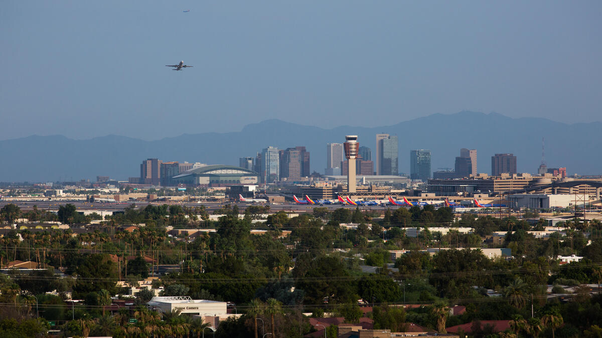 A view of the Phoenix downtown skyline as a plane takes off