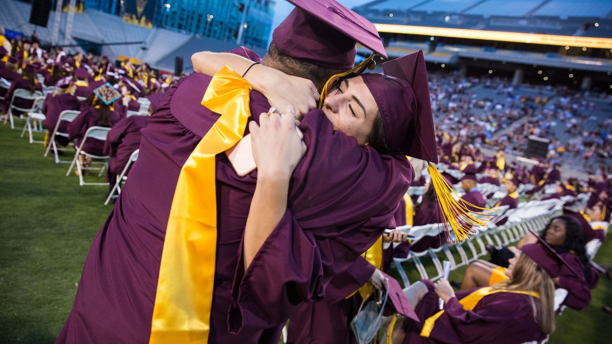 two people hugging at graduation