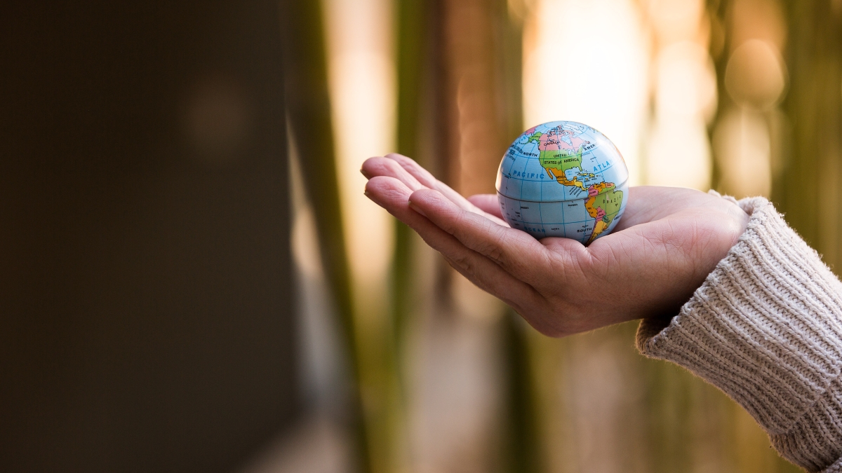 Palm holding small globe in hand
