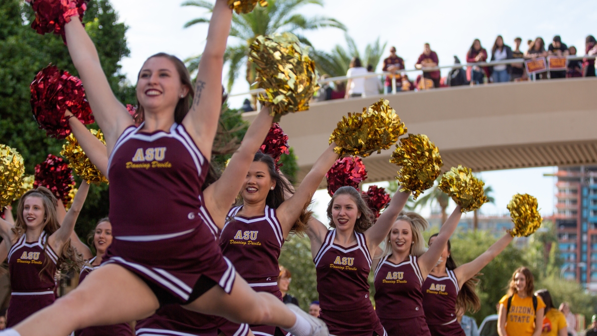 cheerleaders perform at the homecoming parade and block party