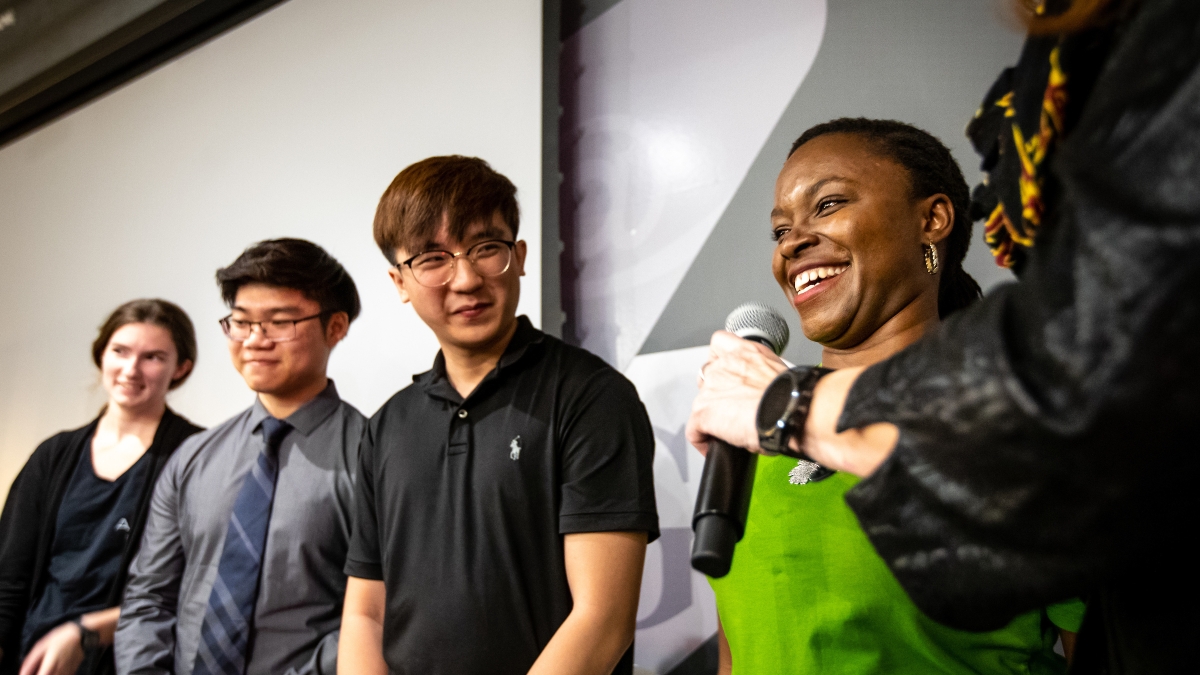 contestants in an entrepreneurial competition standing in a row, smiling