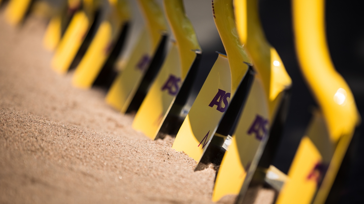 row of shovels in dirt