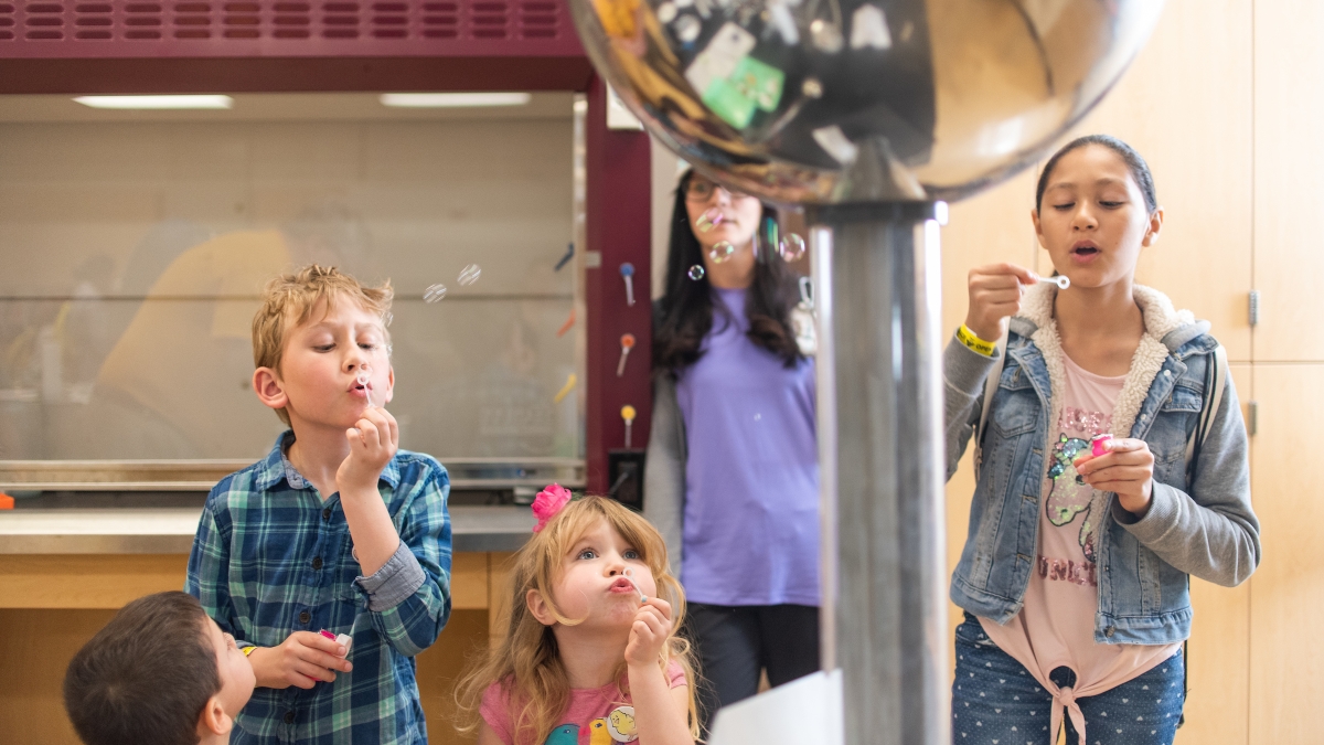 kids blow bubbles at a van de graff generator