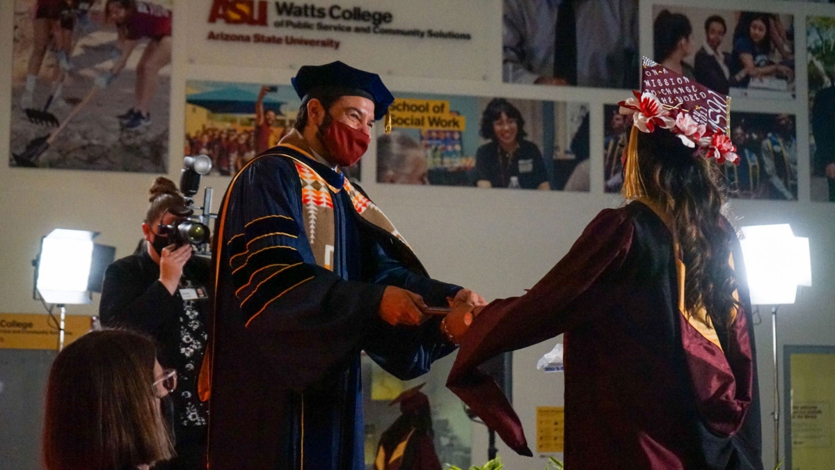 Dean Jonathan Koppell congratulates a spring 2021 Watts College graduate