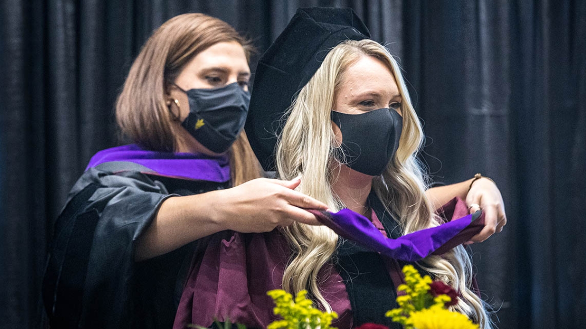 Photo of Kelsey Misseldine, student at Arizona State University's Sandra Day O'Connor College of Law, being hooded by Loni Burnette as part of spring 2021 convocation