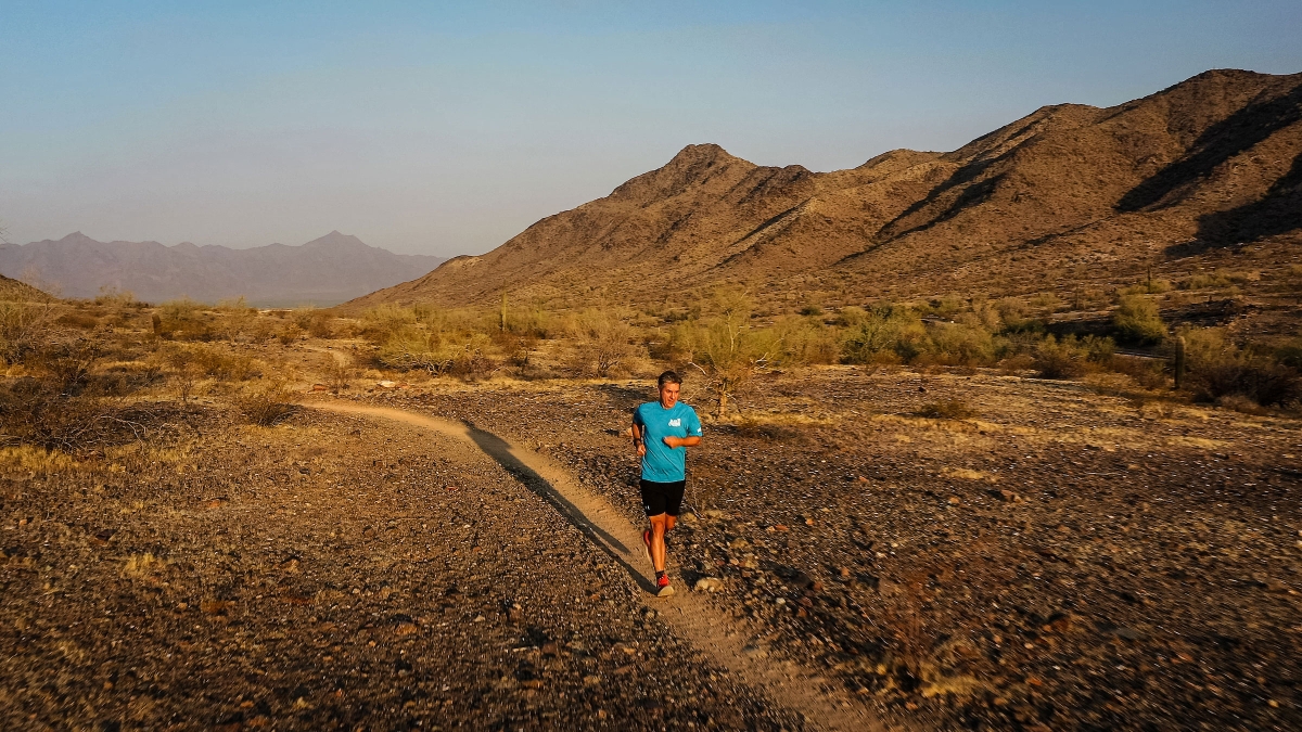 man running on desert trail