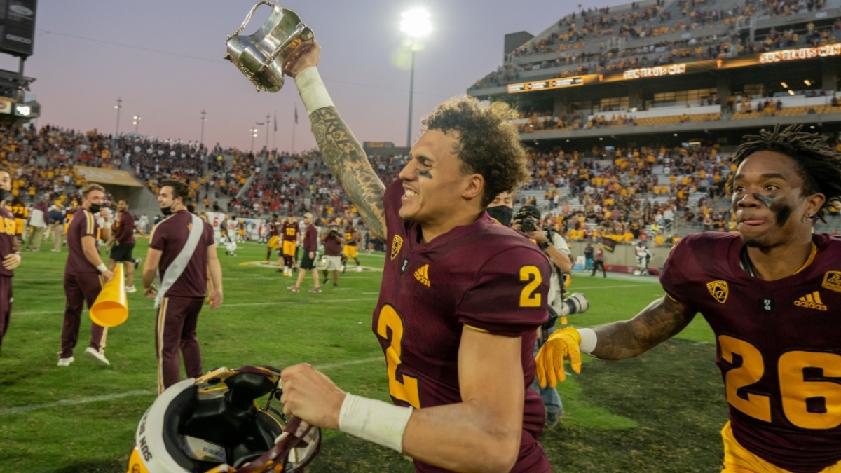 football player holding up Territorial Cup in victory