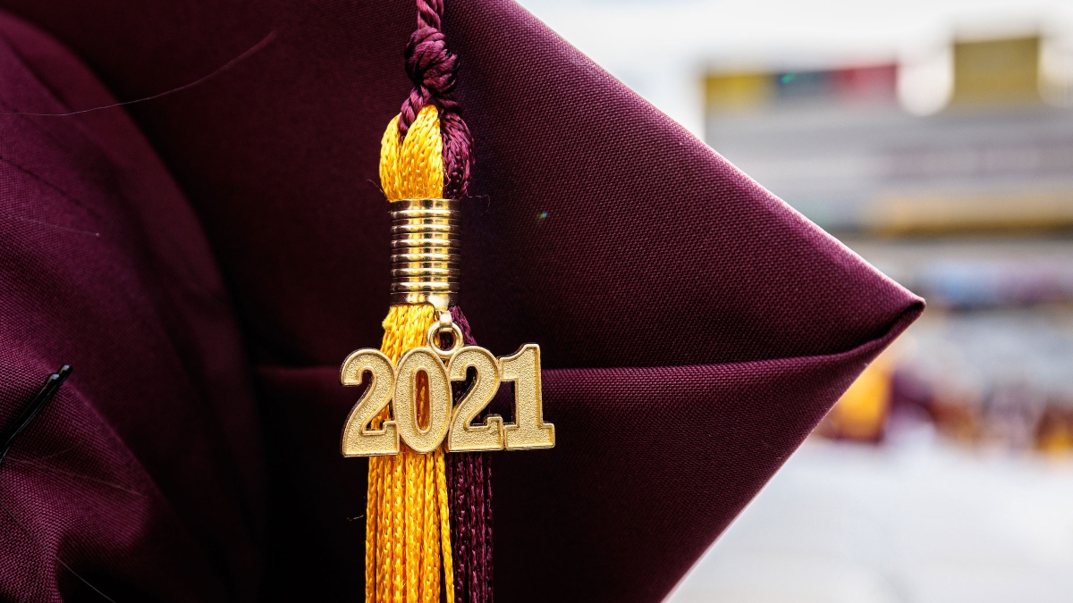 A 2021 tassel hangs from a graduation cap