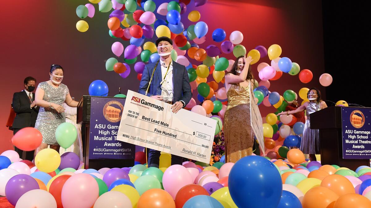 The Best Lead Male and Female winners of the 2021 ASU Gammage High School Musical Theatre Awards stand onstage surrounded by balloons.
