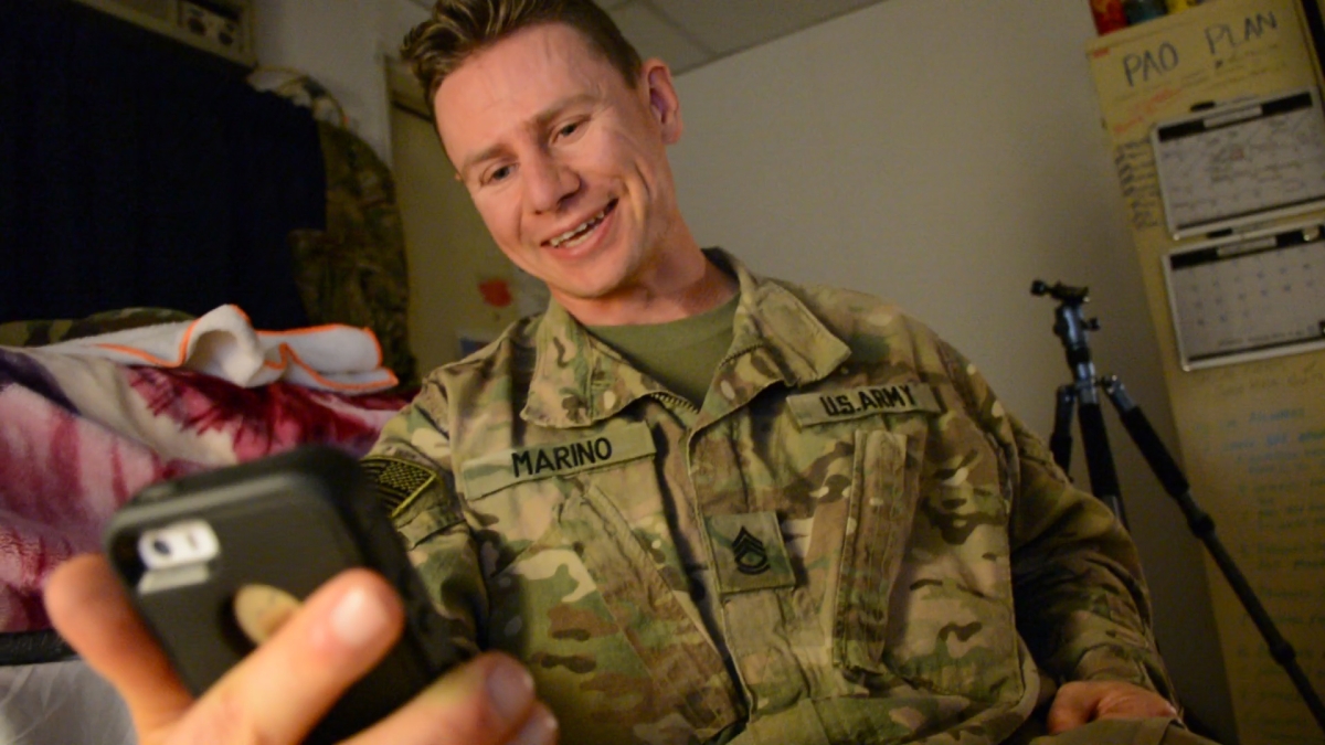Uniformed United States military man, talking to family on phone