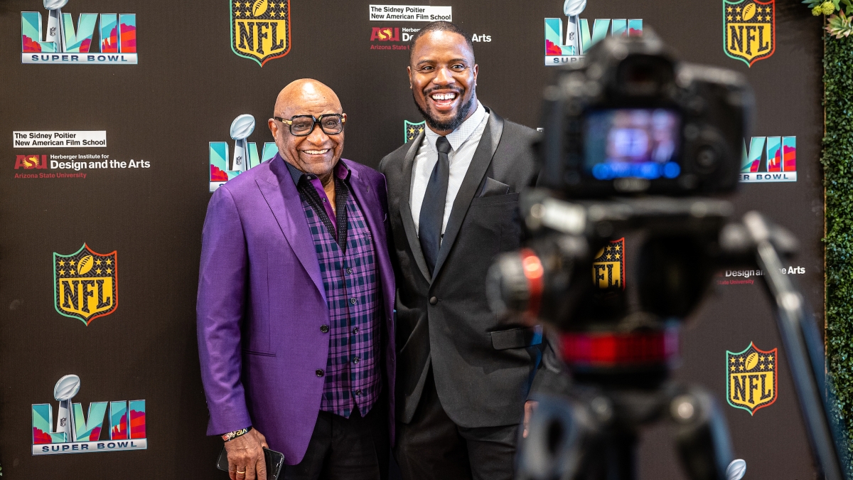 Two men posing for a red carpet event at the ASU Mix Center.