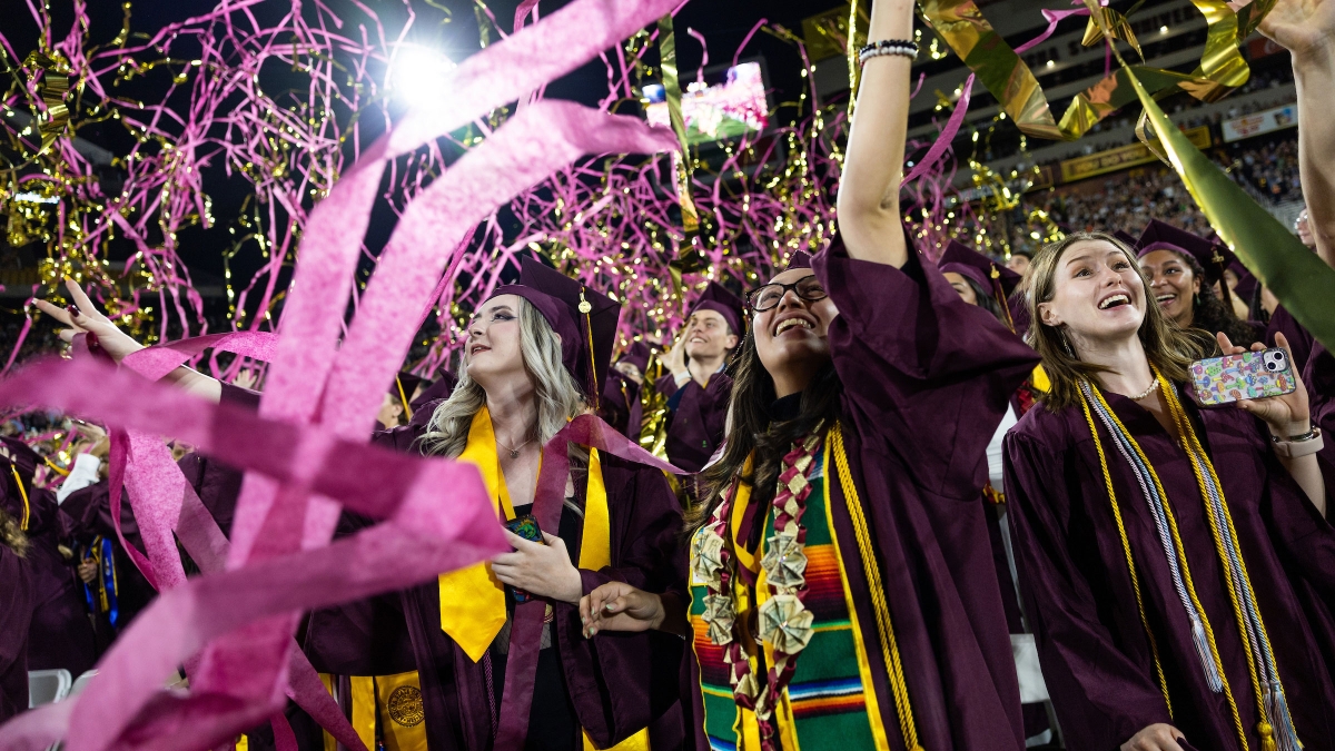 Confetti and ribbons fall on graduates at ASU commencement