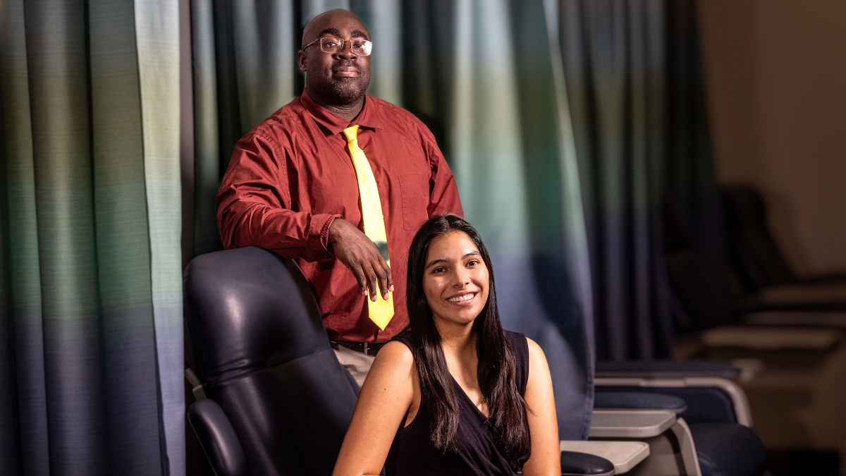 Black professor and Hispanic student pose for a photo in an ASU lab
