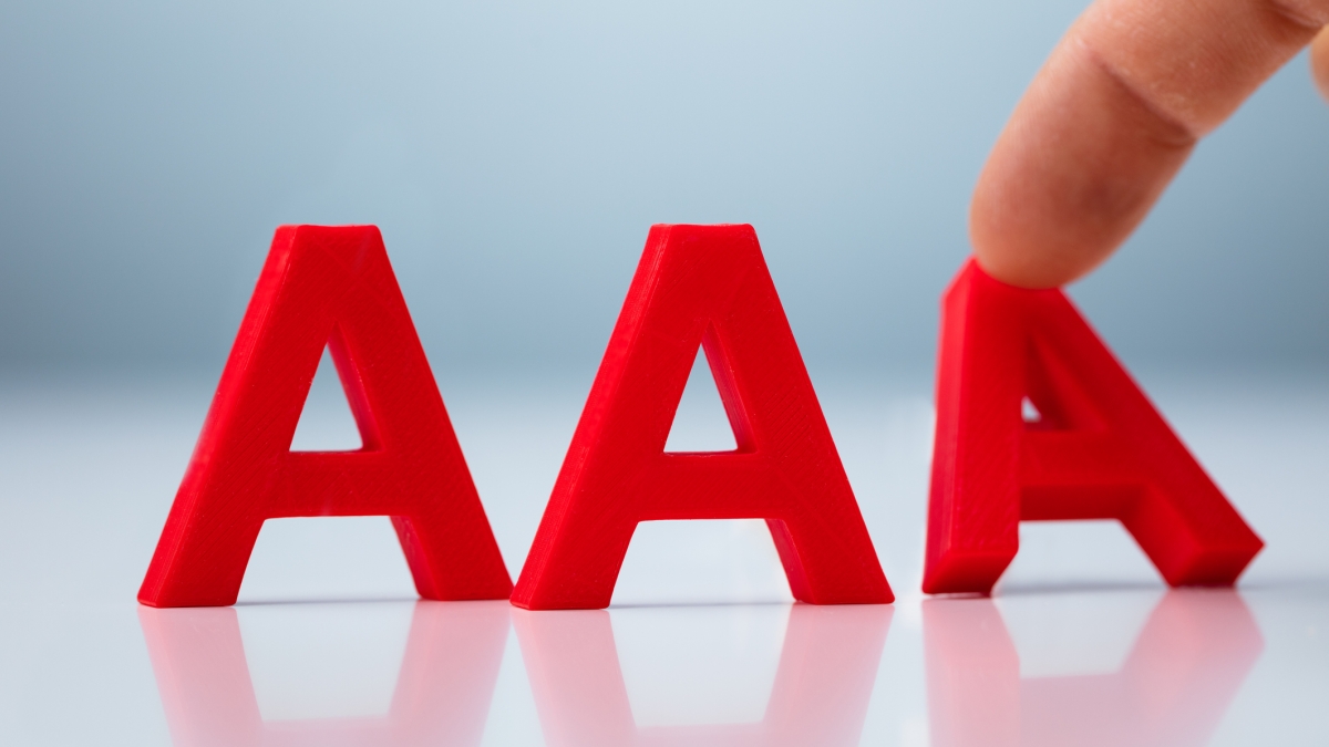 Three three-dimensional letter "A's" and a finger.