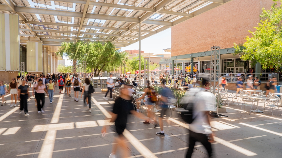Slow shutter image of students walking on ASU's Tempe campus