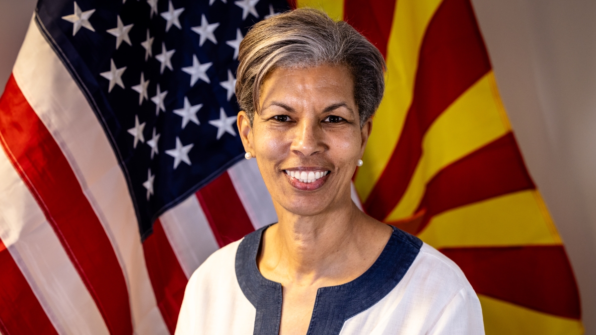 Portrait of Wanda Wright in front of an American flag and an Arizona state flag.