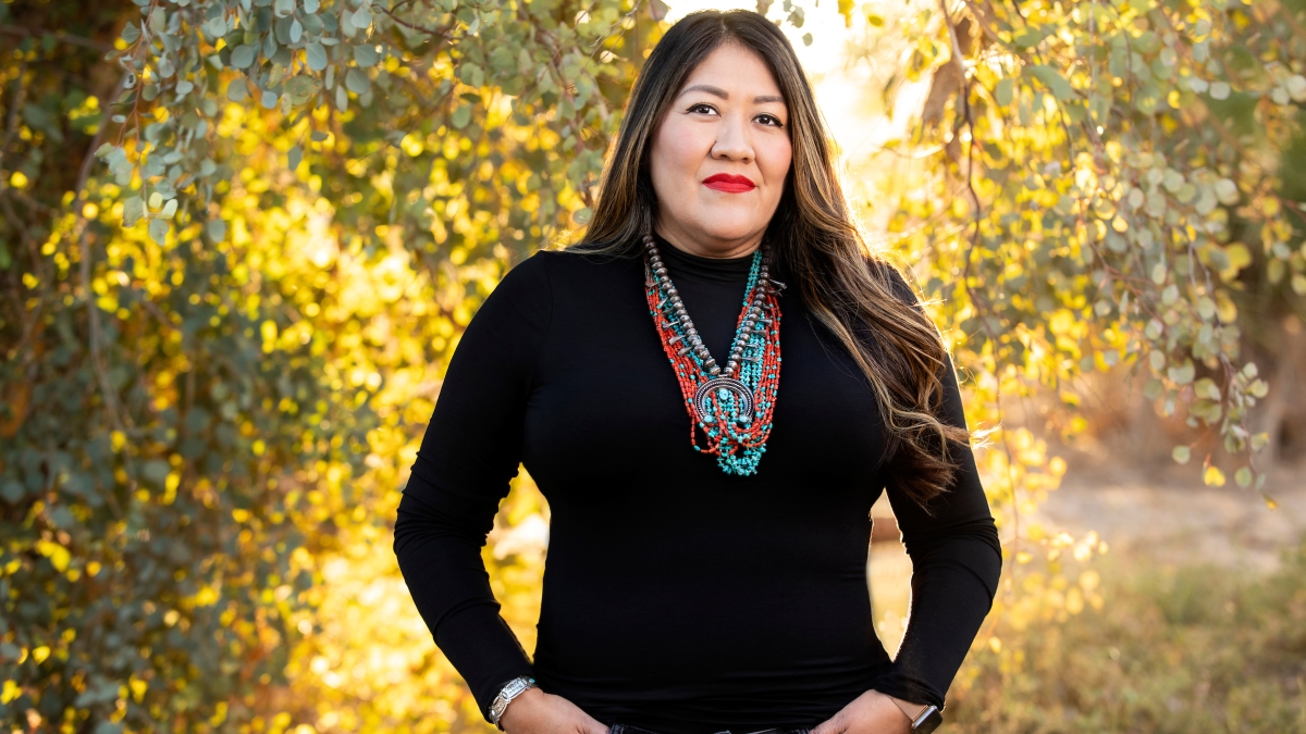 Woman in black turtleneck wearing Native American jewelry
