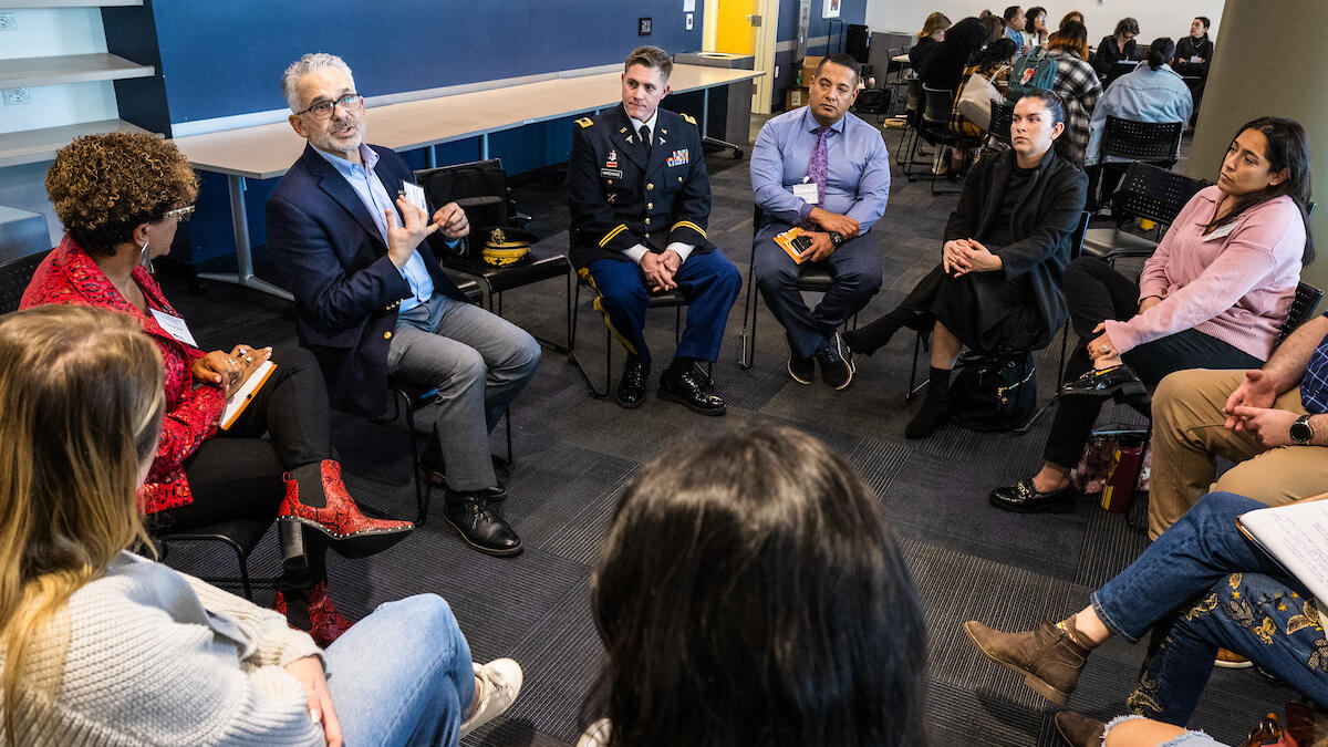 People seated in a circle talking.