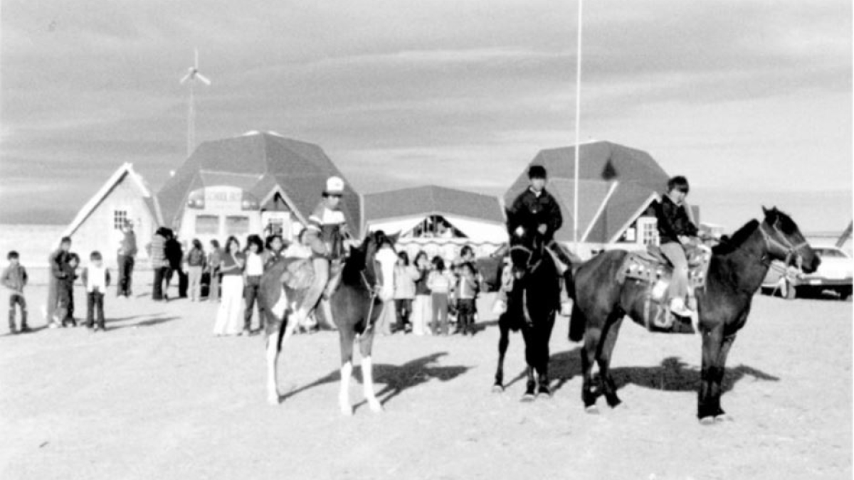 Children on horseback in a black-and-white photo.