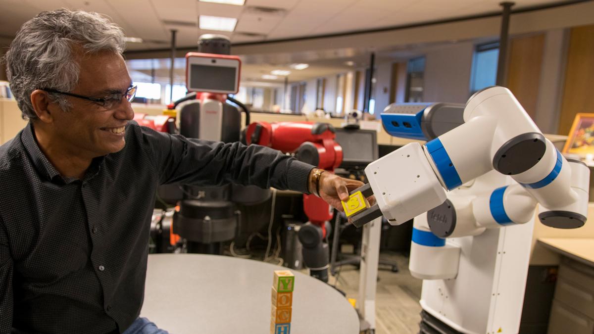 Man using a piece of equipment and smiling.