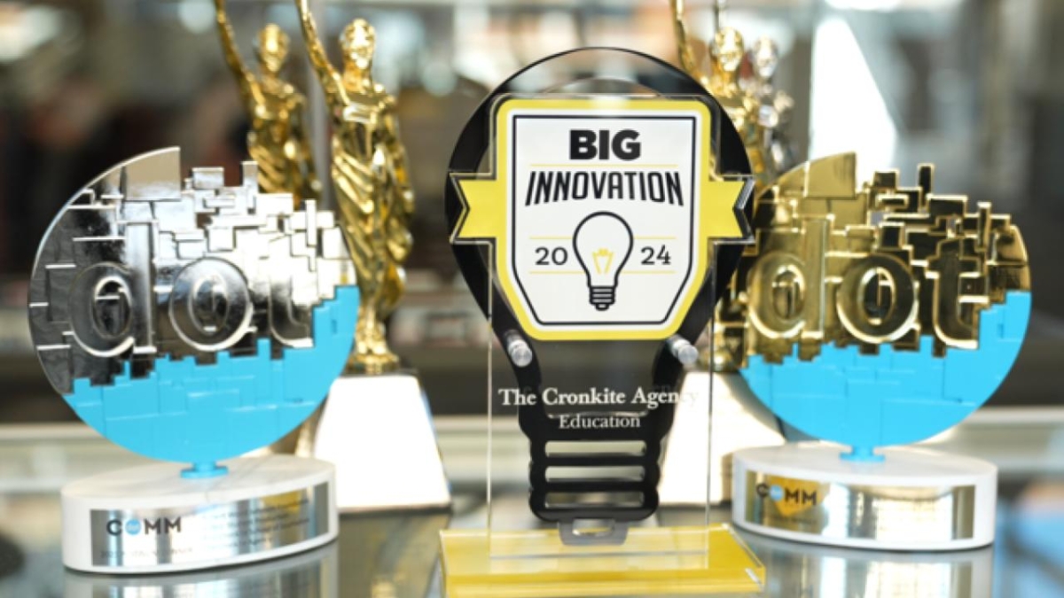 A close-up photo of the Cronkite Agency BIG Innovation Award trophy beside other trophies.