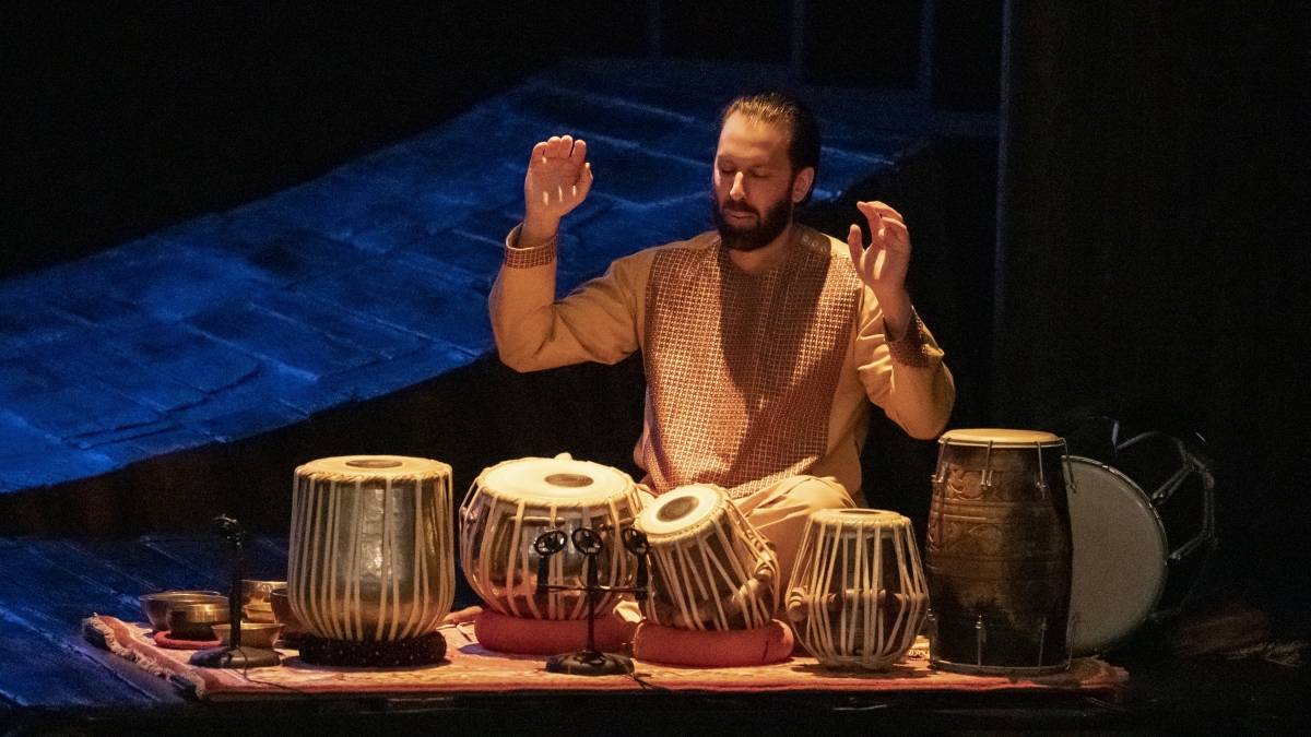 Salar Nader playing the Tabla drum onstage.
