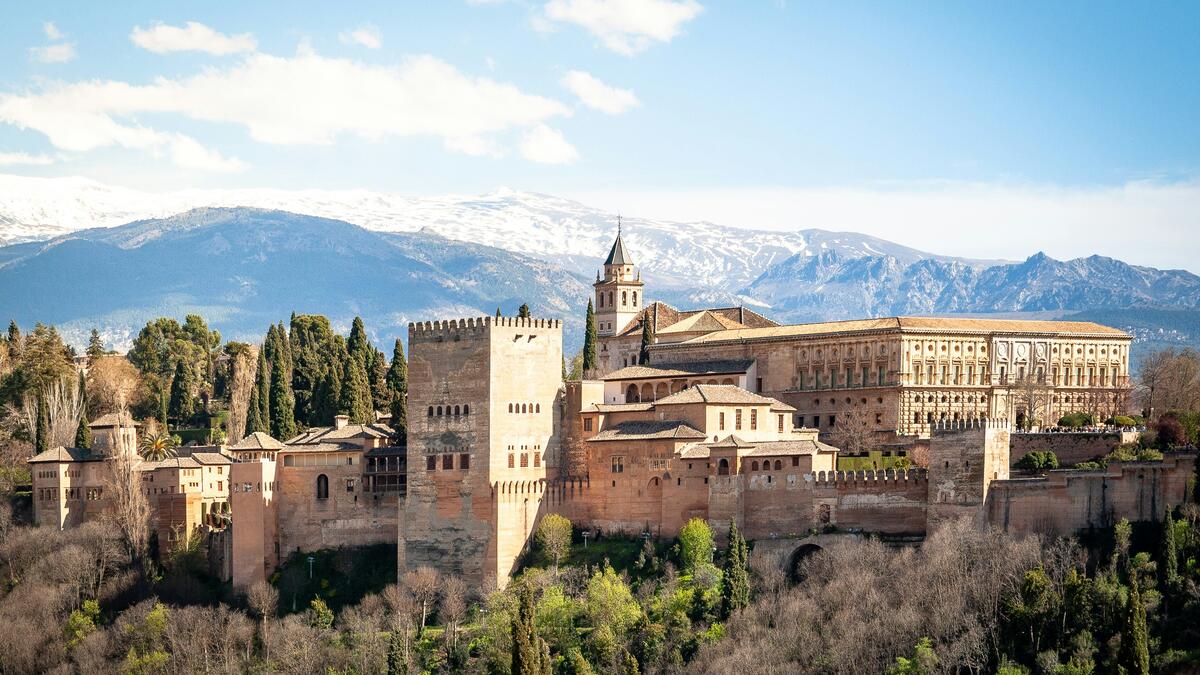 View of a large, old structure on a hilltop in Granada, Spain.