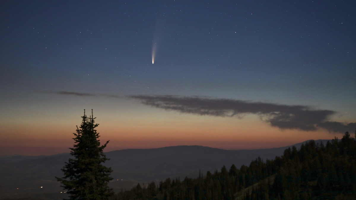 A sunset image showing a comet crossing the far sky